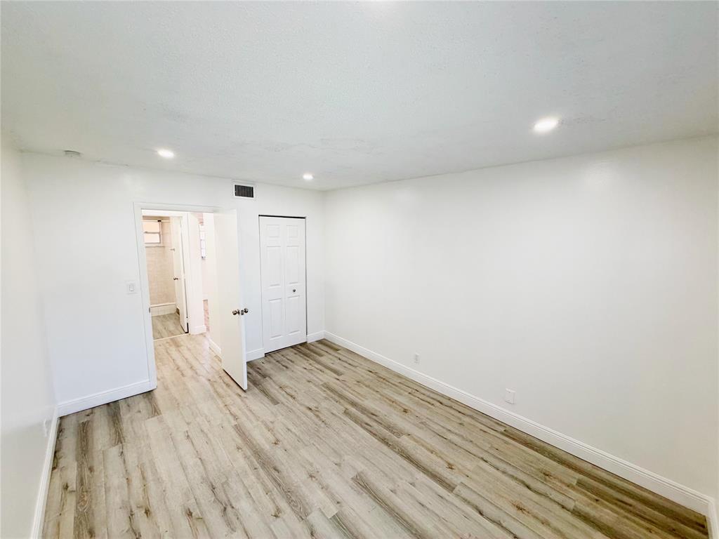2710 Riverside Drive, Unit 201 Coral Springs, FL 33065 - Photo 24 of 37 a view of hallway with wooden floor