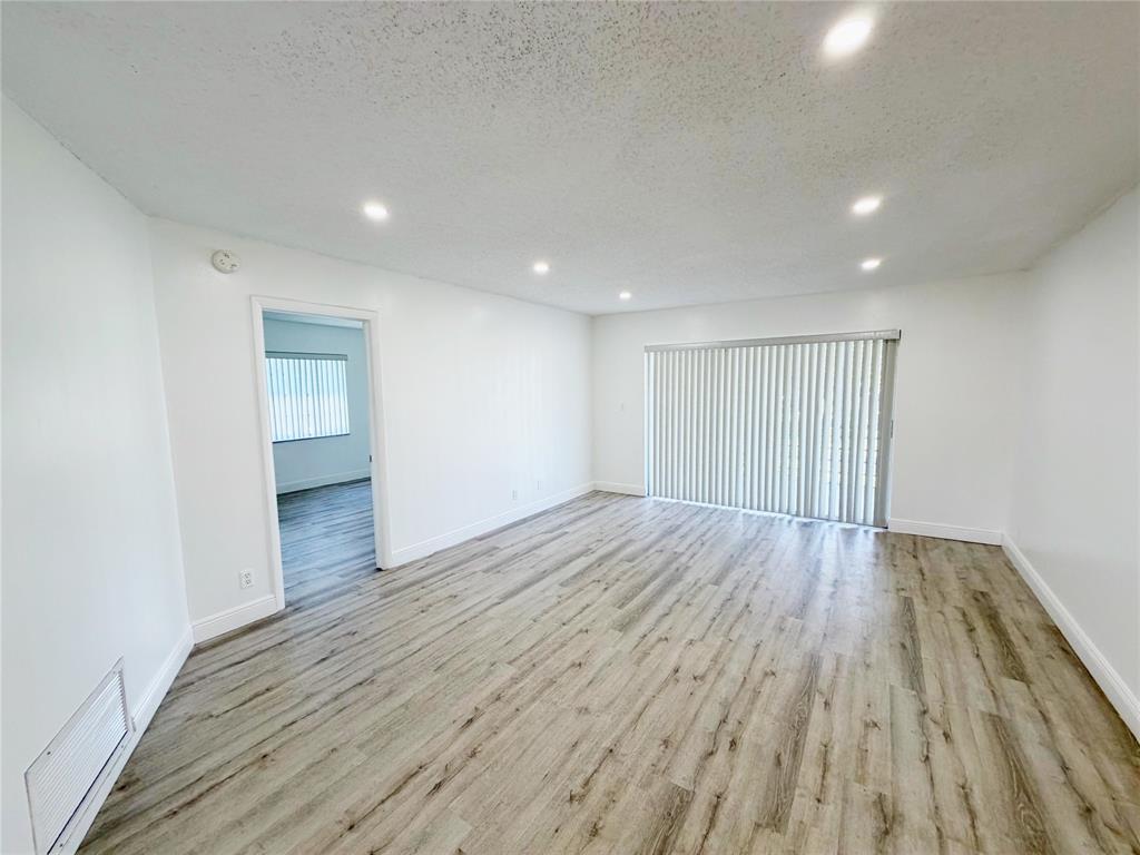 2710 Riverside Drive, Unit 201 Coral Springs, FL 33065 - Photo 9 of 37 a view of empty room with wooden floor