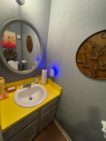 a bathroom with a toilet a sink and a mirror