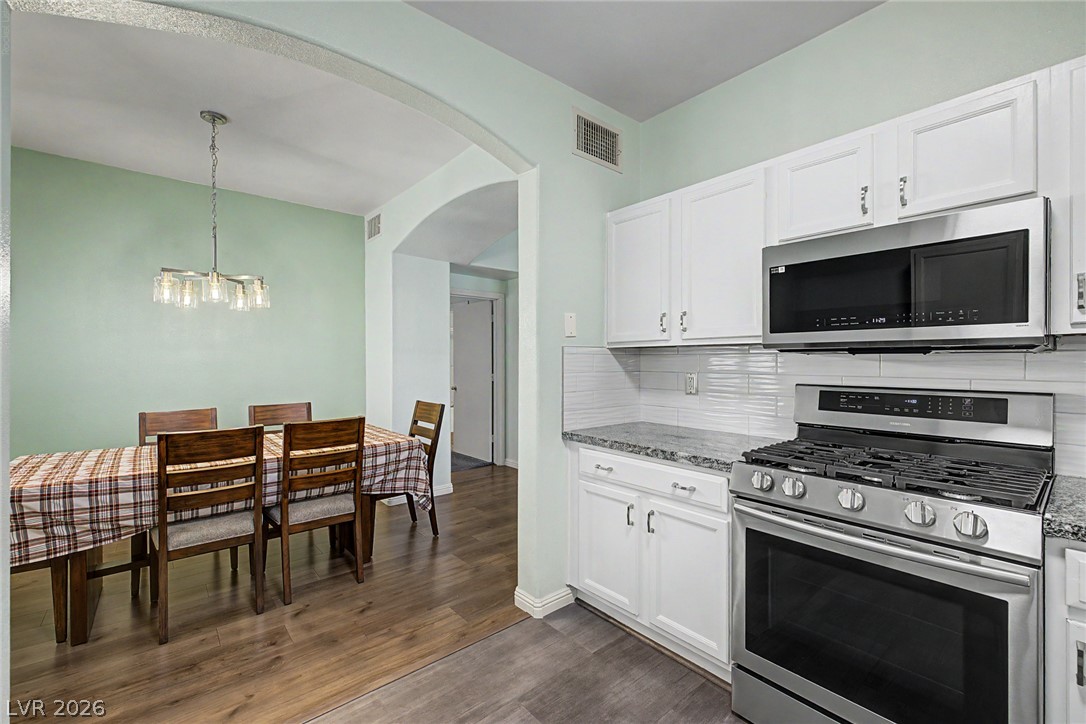 2153 Quarry Ridge Street, Unit 103 Las Vegas, NV 89117 - Photo 3 of 42 Clean lines and a functional layout define this kitchen and adjacent dining area, ideal for daily living.