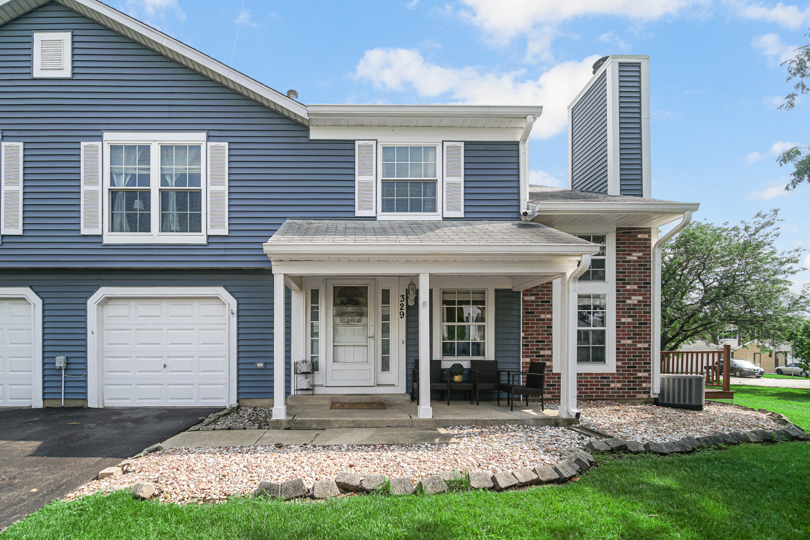 a front view of a house with a yard and porch