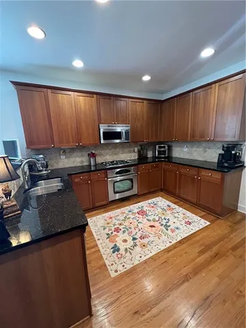 a kitchen with wooden cabinets and a sink