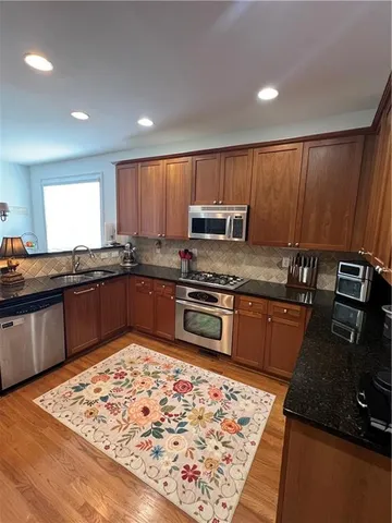 a kitchen with a stove a sink and a microwave