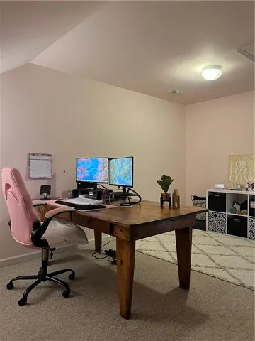 a view of a workspace with furniture