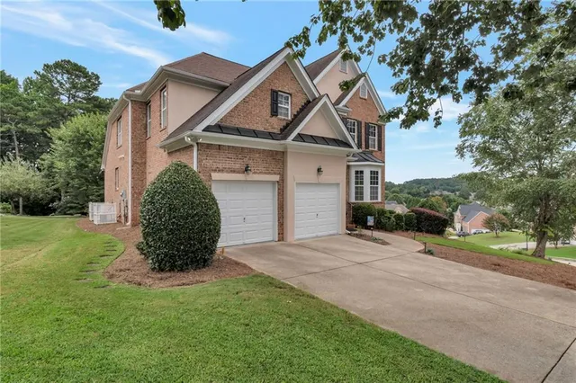 a front view of a house with a yard and garage
