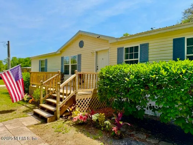 a view of a house with a backyard and sitting area