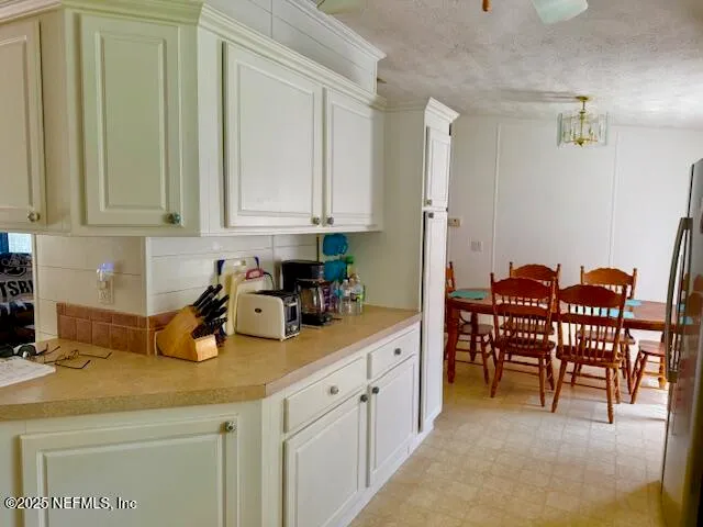 a view of a kitchen with a dining table chairs and a window