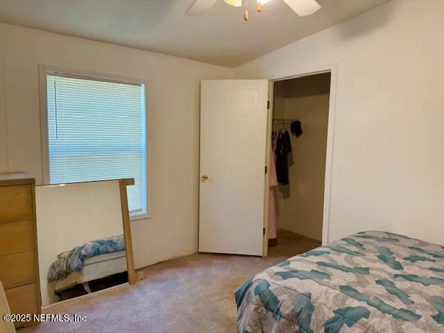 a bedroom with a bed and a closet