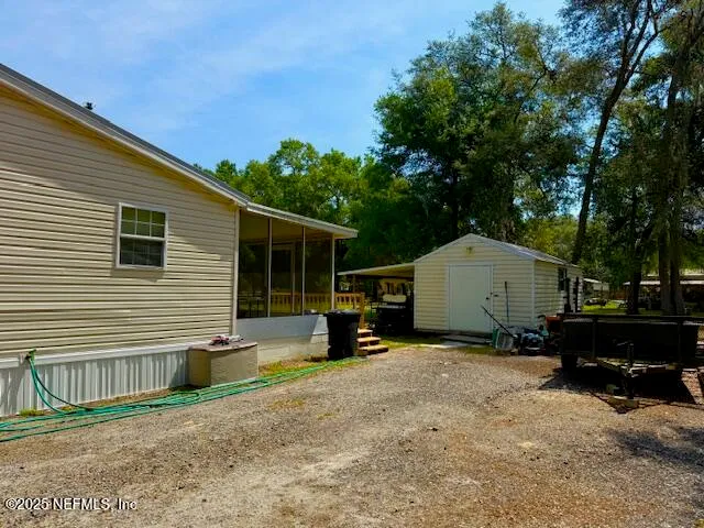 a view of a house with a patio and a yard