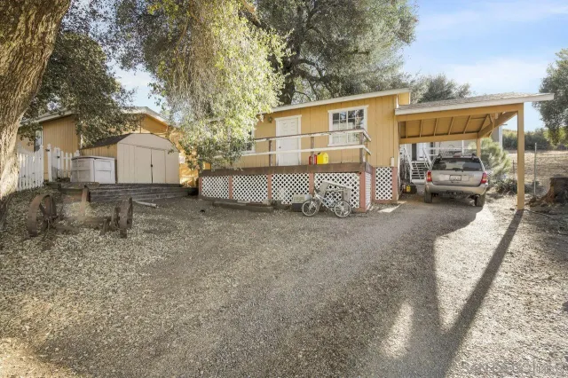 a view of a house with a yard and sitting area