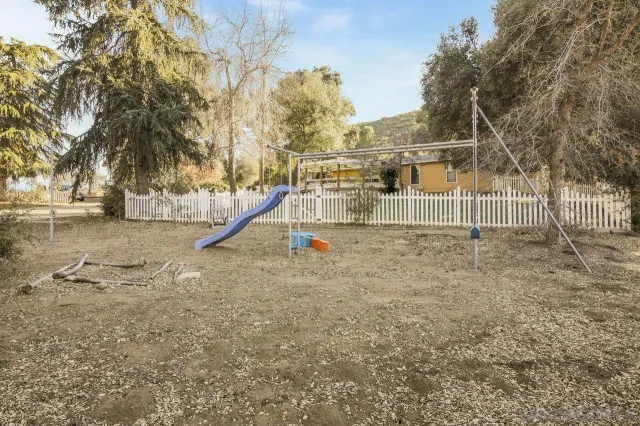 a view of a park with iron fence