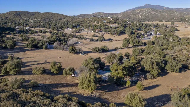an aerial view of mountain with residential house and mountain view