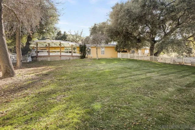 a view of a trees and barn in the back yard