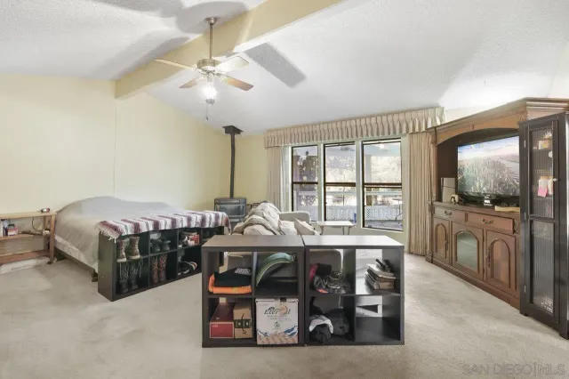 a bedroom with furniture and a large window