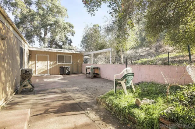 a backyard of a house with yard and outdoor seating