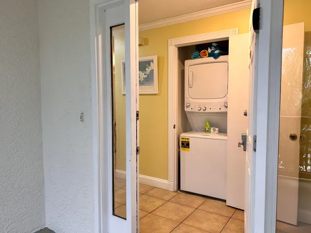 a view of a utility room with front door
