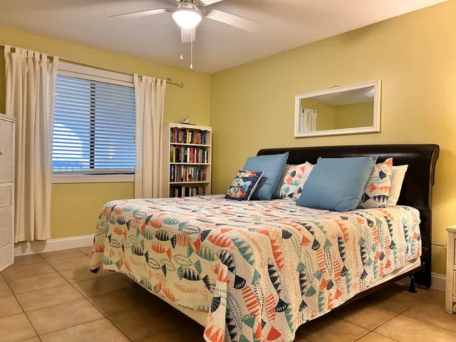 a bedroom with a bed and a mirror