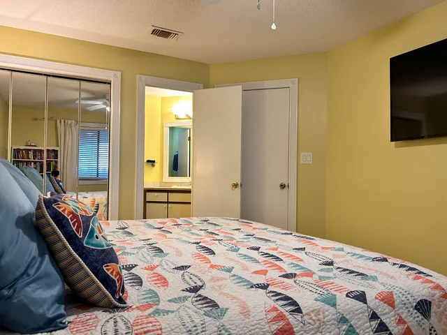 a bedroom with a bed and a flat screen tv