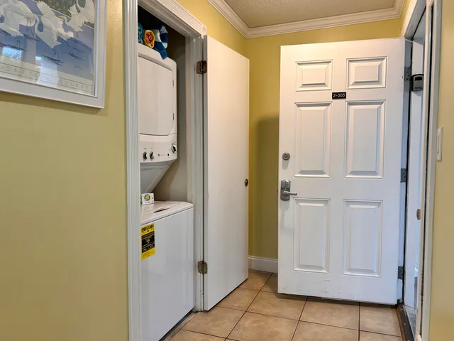 a view of bathroom with a shower and closet