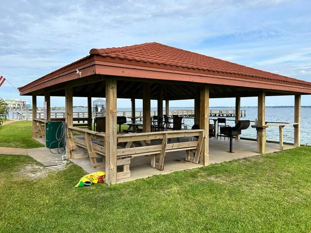 a view of a patio with table and chairs under an umbrella with a couch