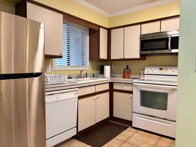 a kitchen with stainless steel appliances a stove microwave and sink