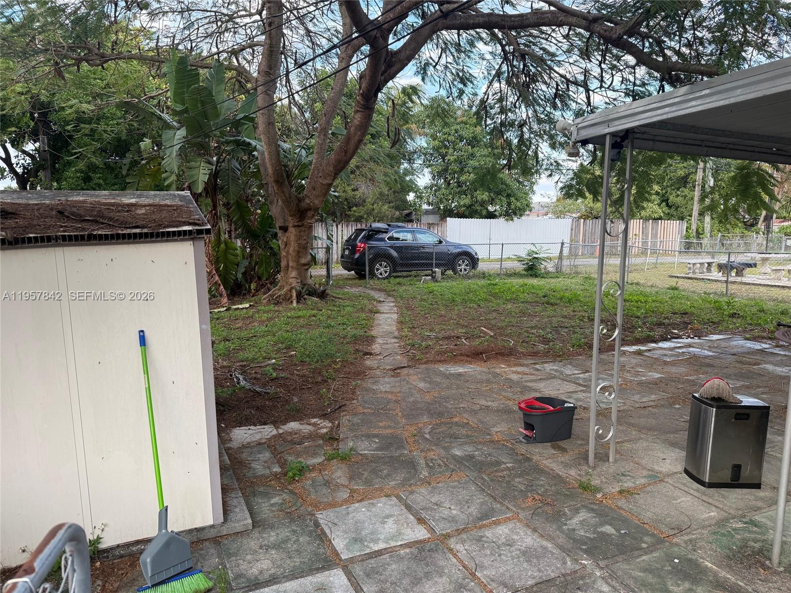 34 Southwest 5th Street, Unit 2 Hallandale Beach, FL 33009 - Photo 12 of 12 a backyard of a house with table and chairs