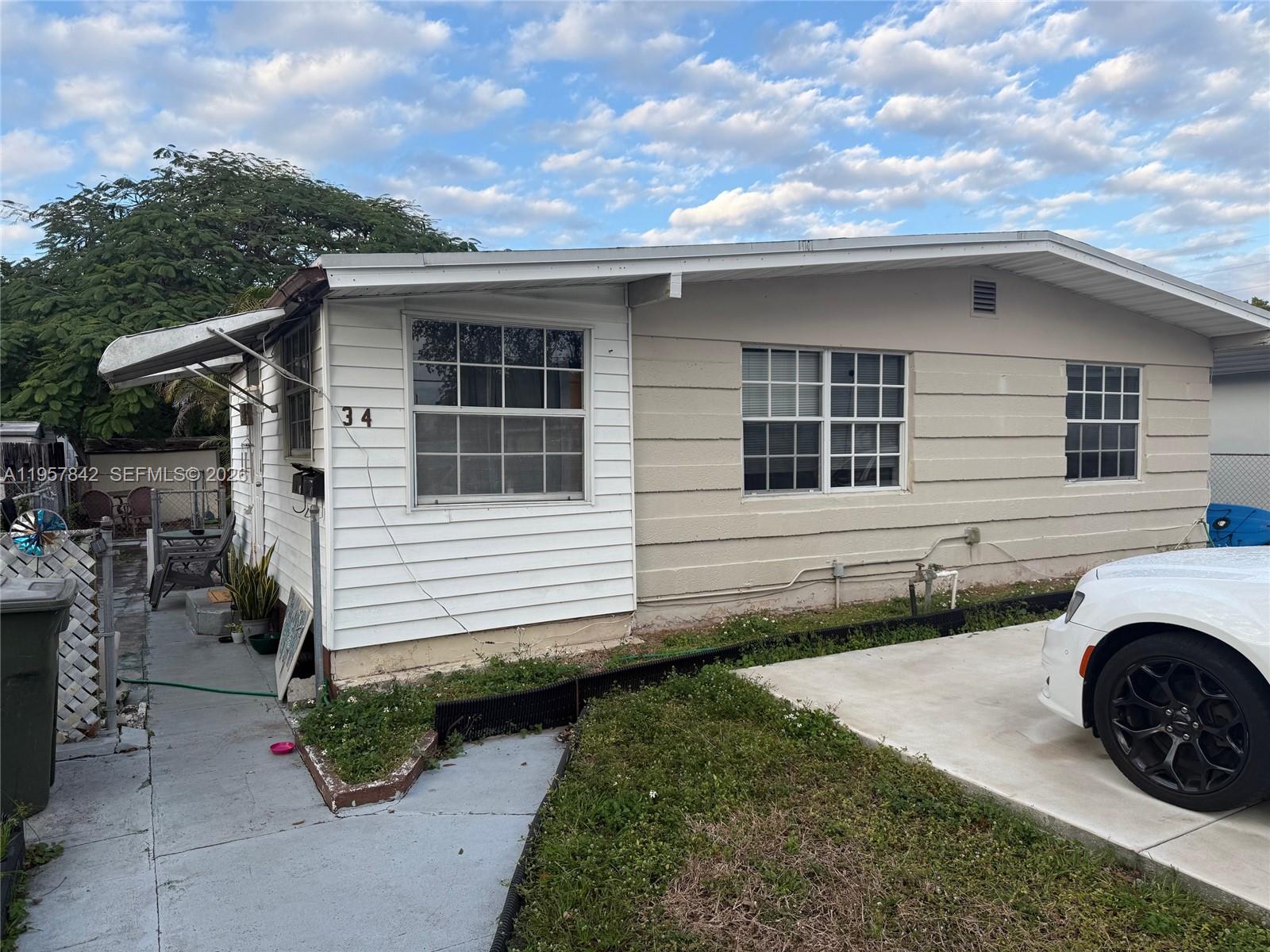 34 Southwest 5th Street, Unit 2 Hallandale Beach, FL 33009 - Photo 2 of 12 a view of a house with a patio