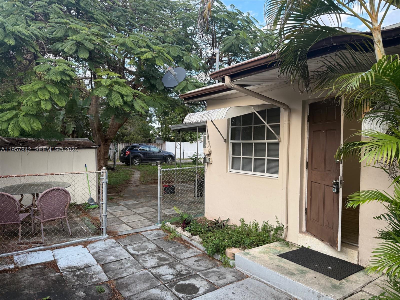 34 Southwest 5th Street, Unit 2 Hallandale Beach, FL 33009 - Photo 3 of 12 a backyard of a house with lots of green space