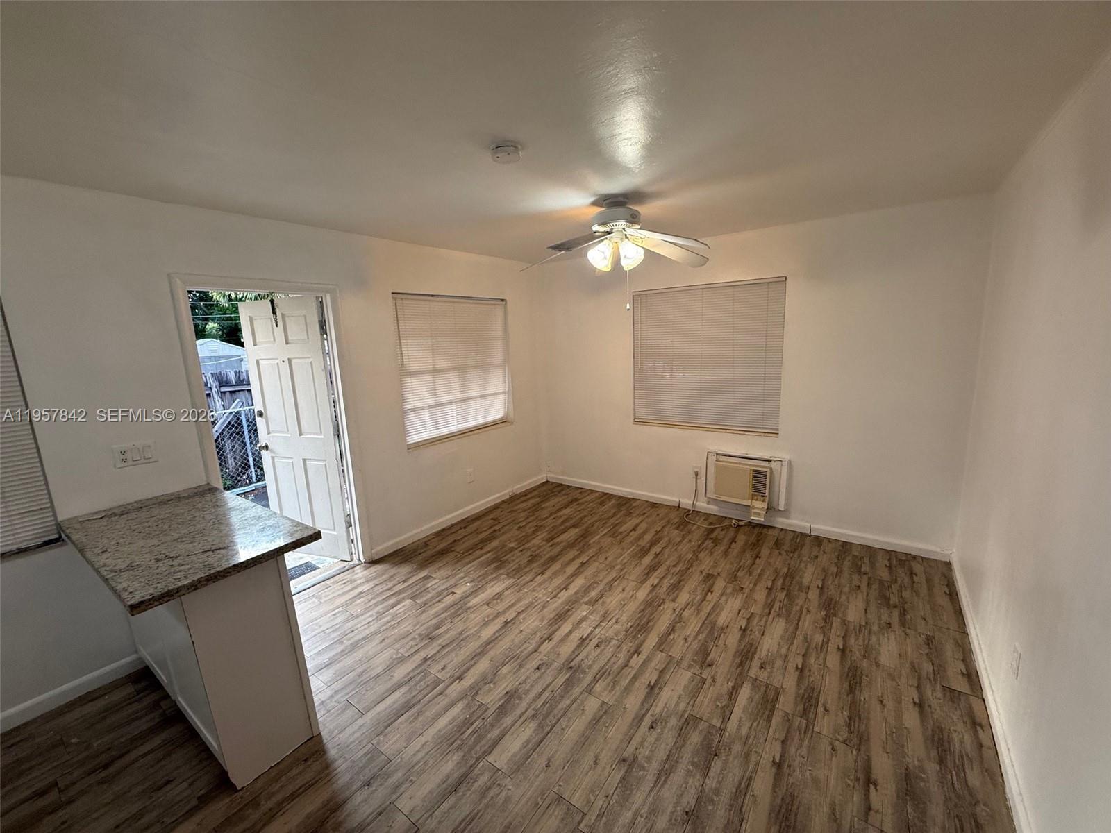 34 Southwest 5th Street, Unit 2 Hallandale Beach, FL 33009 - Photo 9 of 12 wooden floor in an empty room with a window