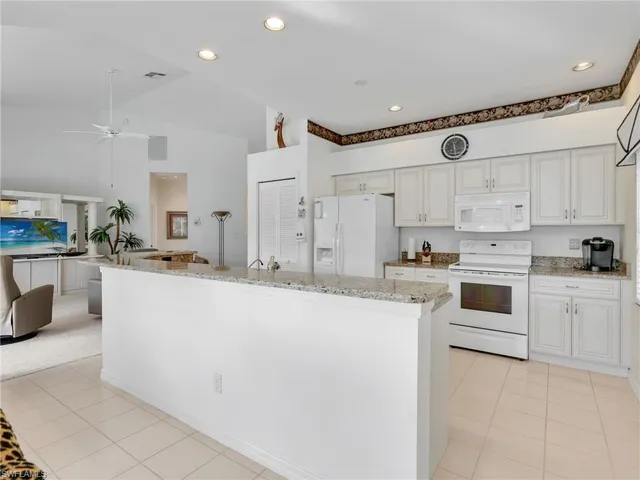 a kitchen with stainless steel appliances and white cabinets