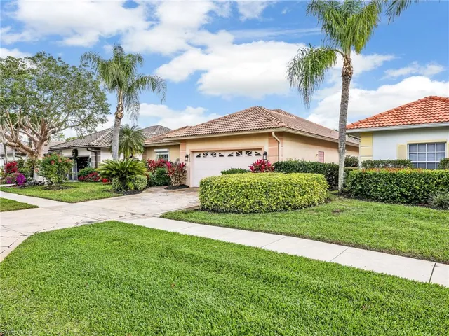 a view of a house with a big yard and potted plants