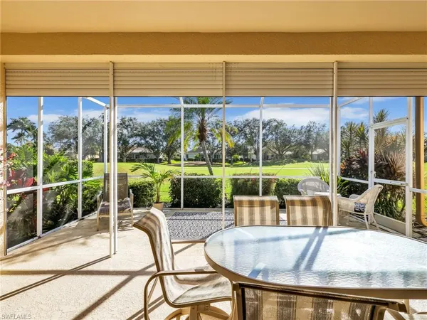 a view of a dining room with furniture and a chandelier