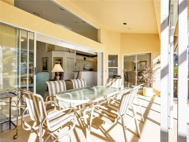 a view of a dining room with furniture water view and a floor to ceiling window