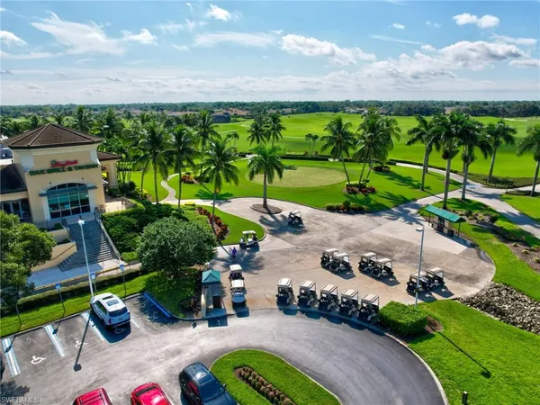 an aerial view of residential houses with outdoor space and trees