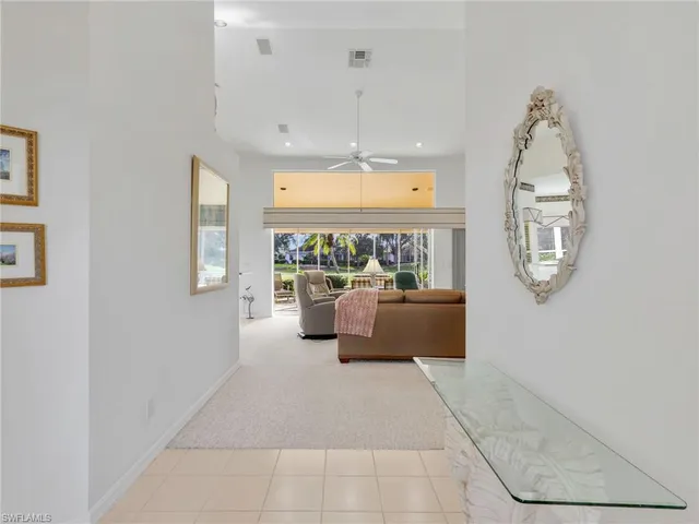 a view of a room with window and chandelier