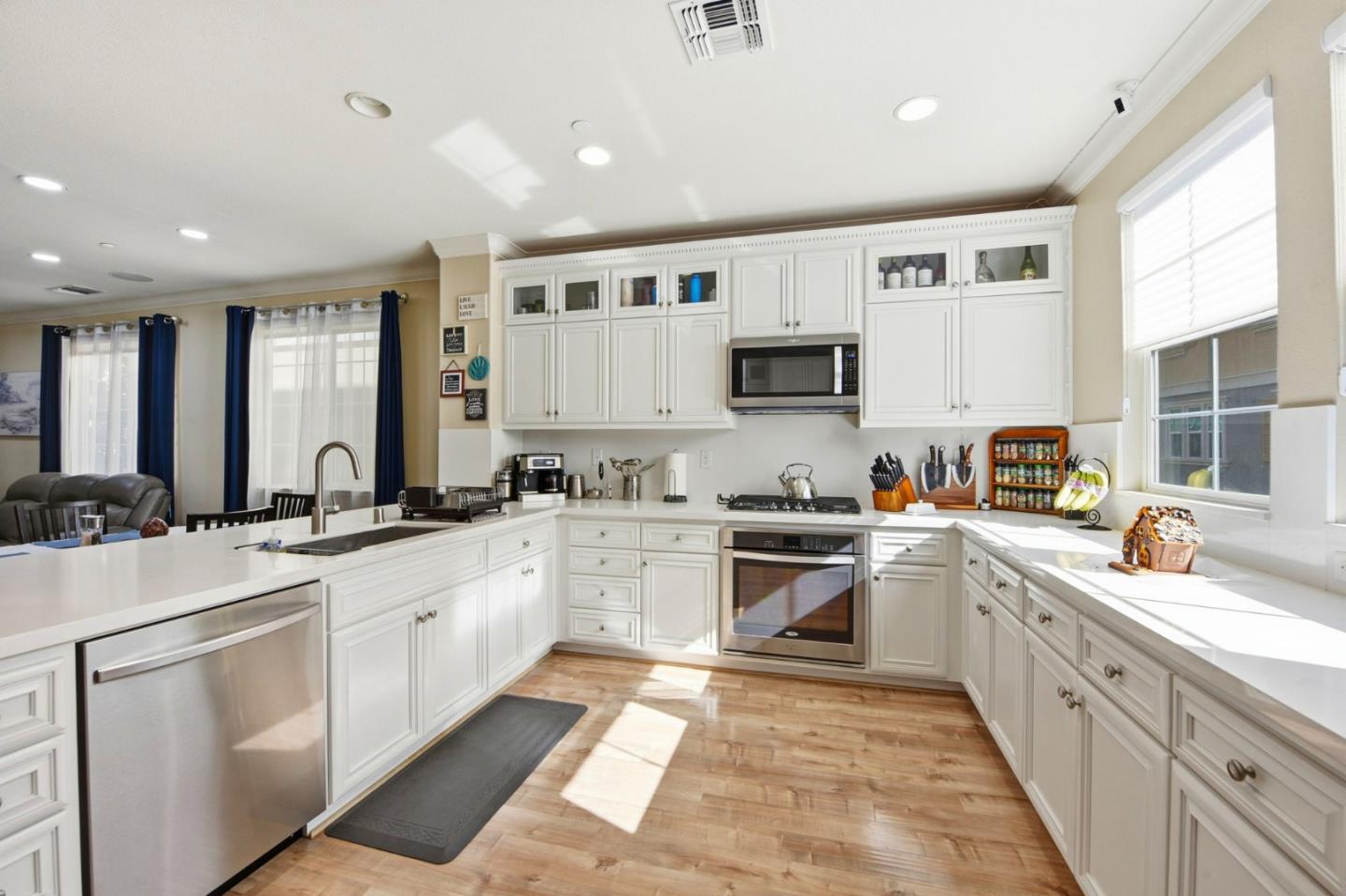 56 Regency Place Hayward, CA 94544 - Photo 12 of 43 a large white kitchen with stainless steel appliances granite countertop a sink and cabinets