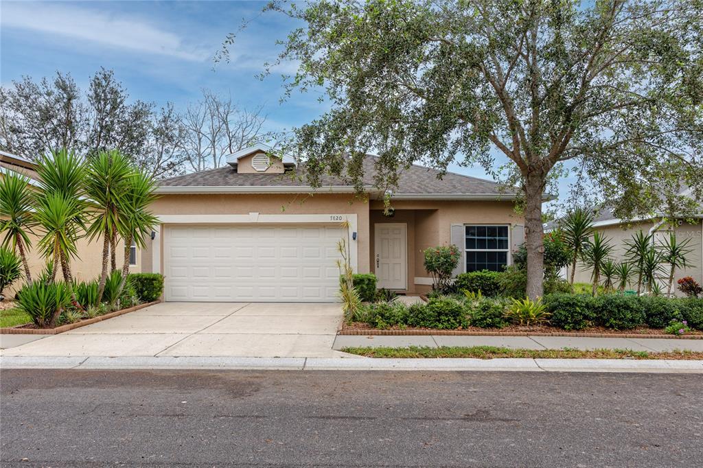 7820 Harbor Bridge Boulevard New Port Richey, FL 34654 - Photo 1 of 1 a front view of a house with a yard and garage