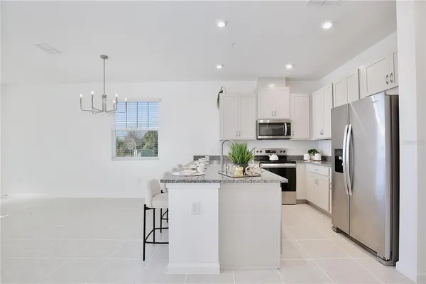 a kitchen with a refrigerator and a sink