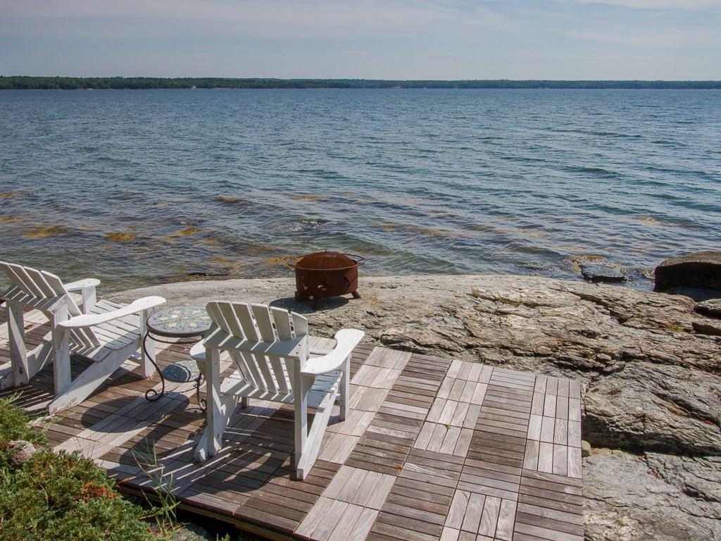 506 Newbury Neck Road Surry, ME 04684 - Photo 26 of 35 A seasonal Ipe wood parquet deck is...