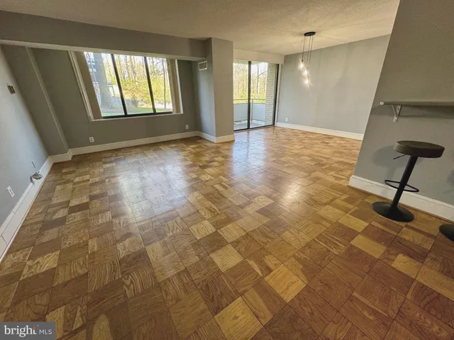 a view of a room with wooden floor