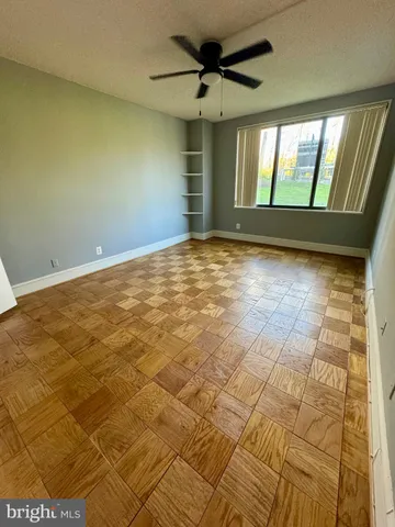 a view of a big room with wooden floor and a bathroom