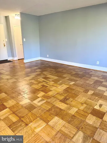 a view of a bench in a backyard with large trees