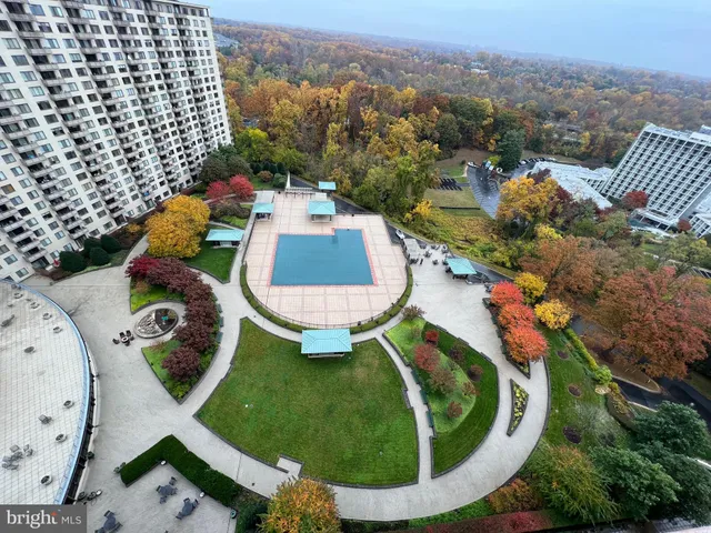 a view of a green field with trees in the background