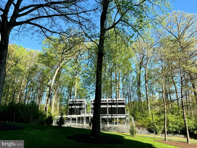 a room with gym equipment and large windows