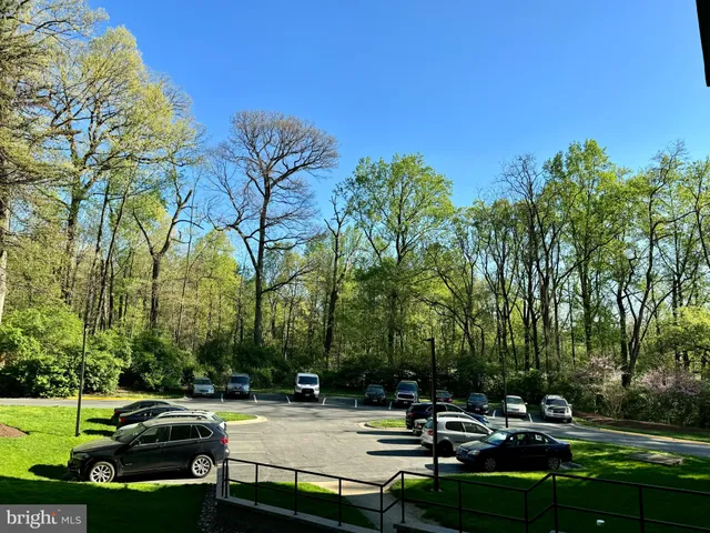 a view of a white house with a floor to ceiling window