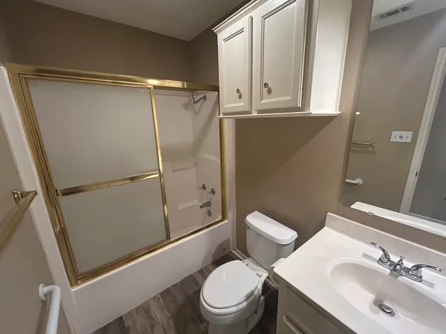 a white toilet sitting next to a bathroom sink
