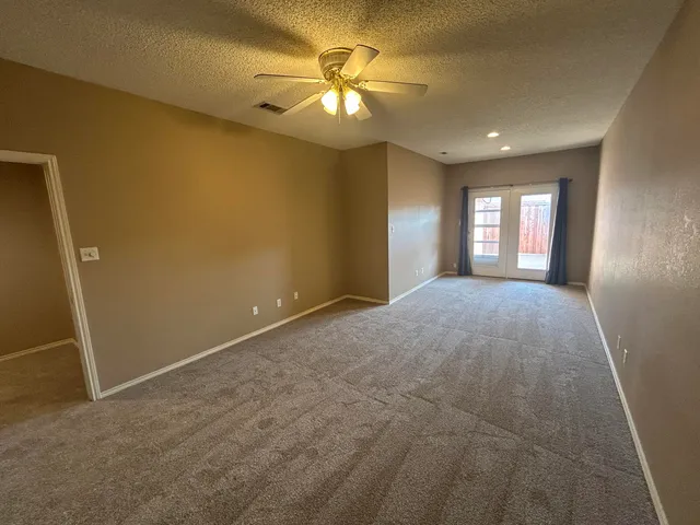 a view of a livingroom with a ceiling fan and window