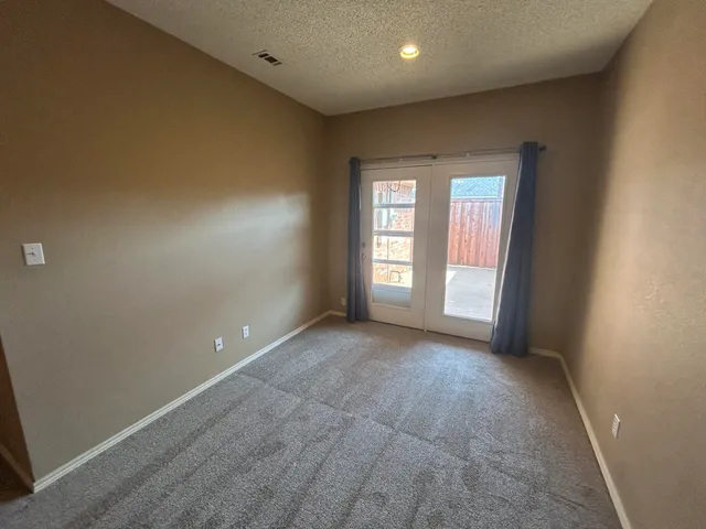 an empty room with windows and closet