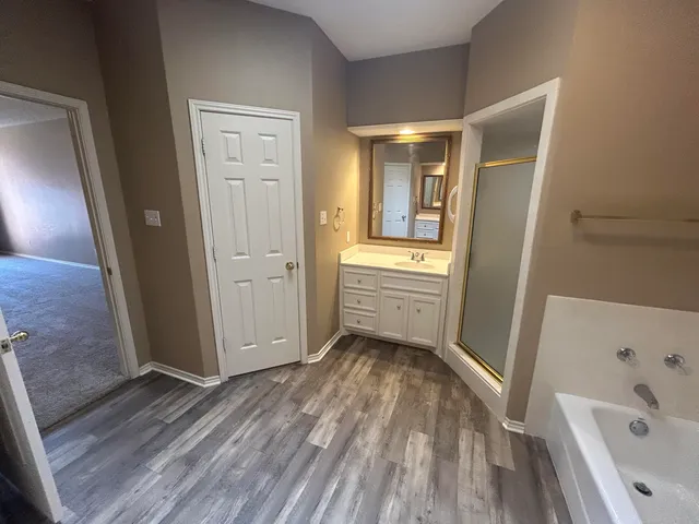 a bathroom with a bathtub and a sink