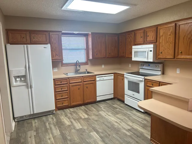 a kitchen with a stove sink and refrigerator